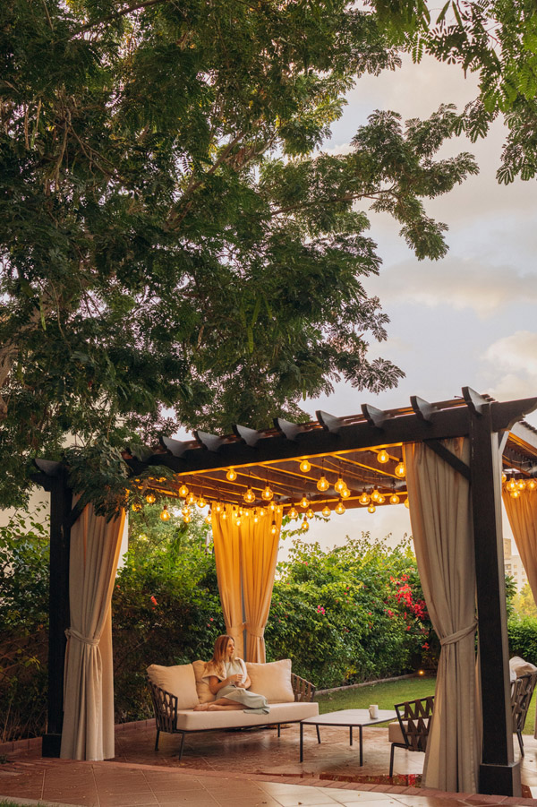 Covered patio with outdoor fireplace and seating built by Keystone Construction