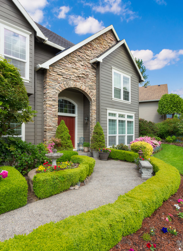 Home with a stone facade and siding on Long Island